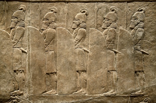 Assyrian relief sculpture panel of soldiers lining the road from the King Ashurnasirpal lion hunt.  From Nineveh  North Palace, Iraq,  668-627 B.C.  British Museum Assyrian  Archaeological exhibit no ME 120859